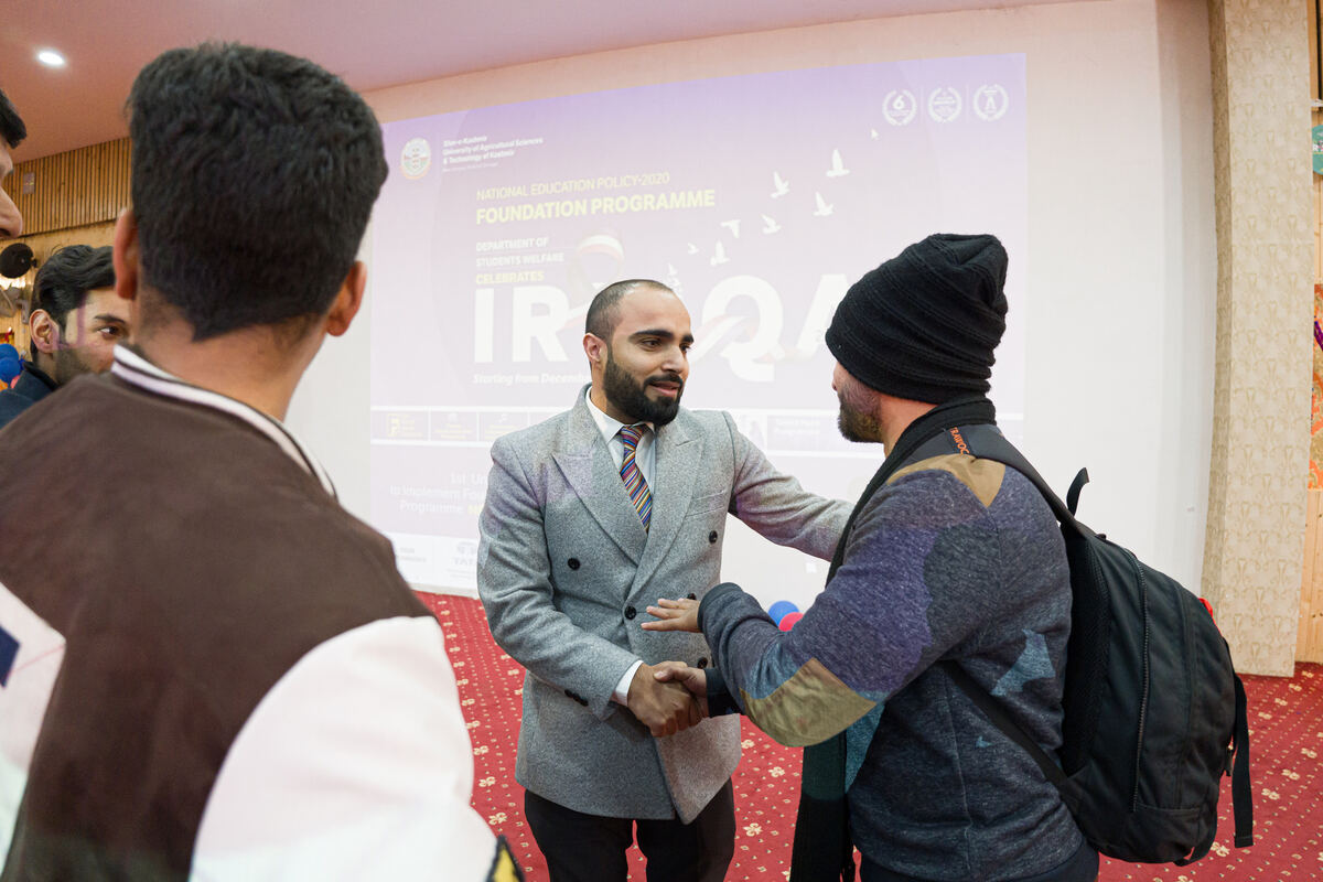 Farhat greeting a participant after a session